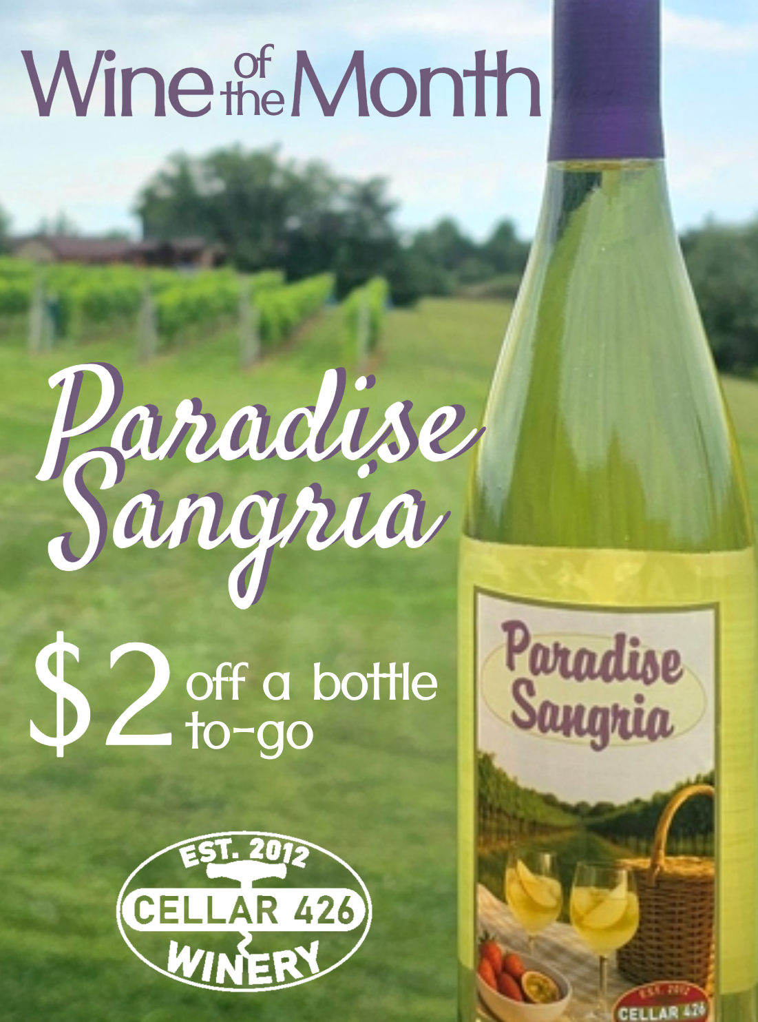 White wine bottle with vineyard in the background